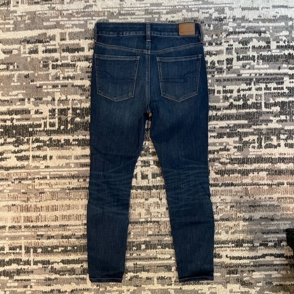American Eagle | Highrise Next Level Stretch Destressed Dark Blue Jean - Picture 4 of 11